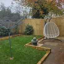 Completed garden transformation Suffolk — Finished garden transformation with turf, fencing, raised beds, and patio