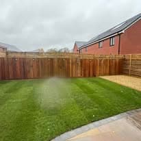 Completed garden transformation Suffolk — Newly laid turf lawn with new fencing installation, finished garden transformation