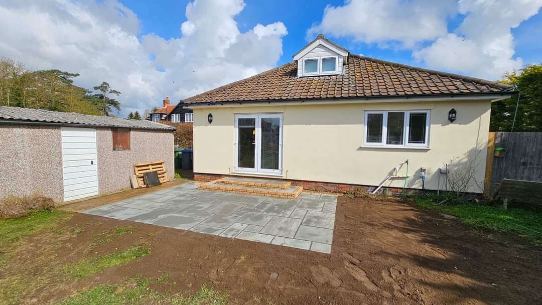 Completed garden transformation Suffolk — Newly installed patio with fresh landscaping transformation complete
