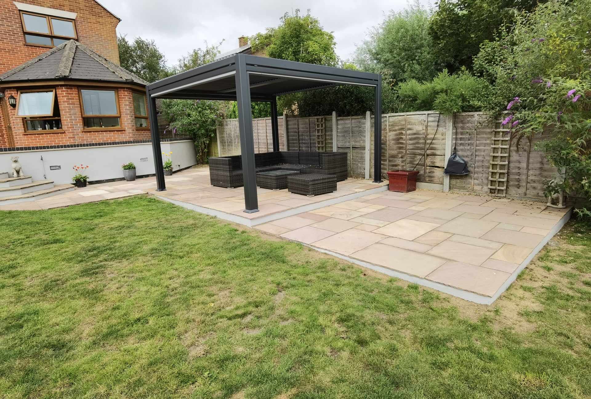Completed garden transformation Suffolk — Finished garden transformation with patio, pergola, and manicured lawn