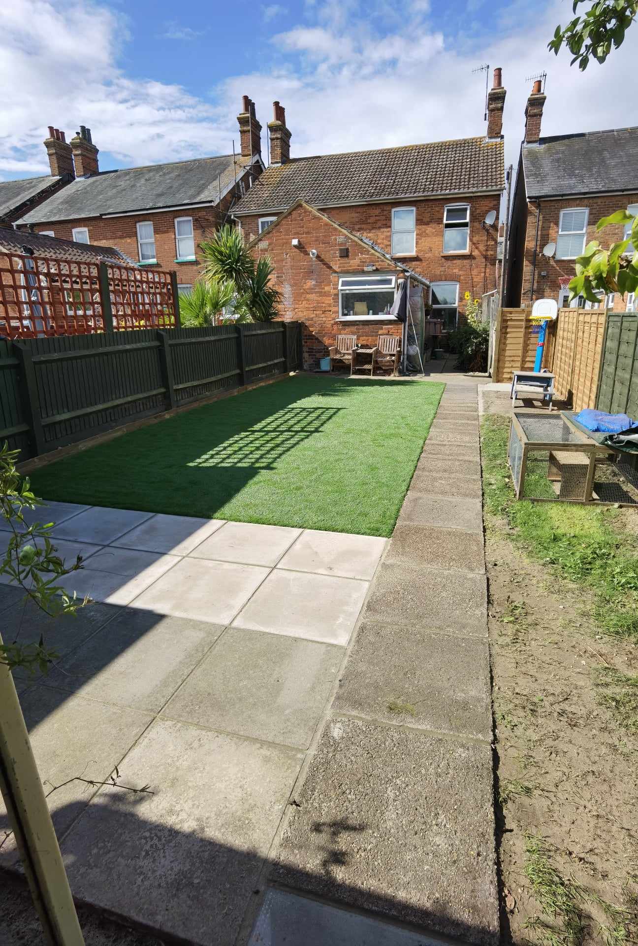 Completed garden transformation Suffolk — Finished garden transformation with new artificial grass, patio, and fencing