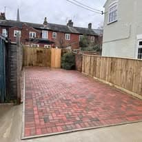 Driveway installation Suffolk — Block paved driveway with red and charcoal colored blocks in herringbone pattern