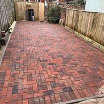 Driveway installation Suffolk — Block paved driveway with herringbone pattern and dark border detailing