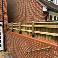 Fencing & gates Suffolk — Wooden fence panels installed against brick wall