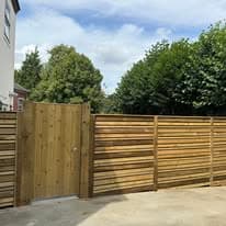 Fencing & gates Suffolk — Wooden fence panels with gate dominate the composition