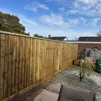 Fencing & gates Suffolk — New wooden fence installation with gravel garden area visible