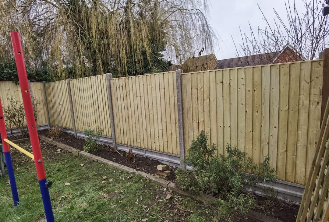 Fencing & gates Suffolk — New wooden fence panels installed along garden perimeter with posts