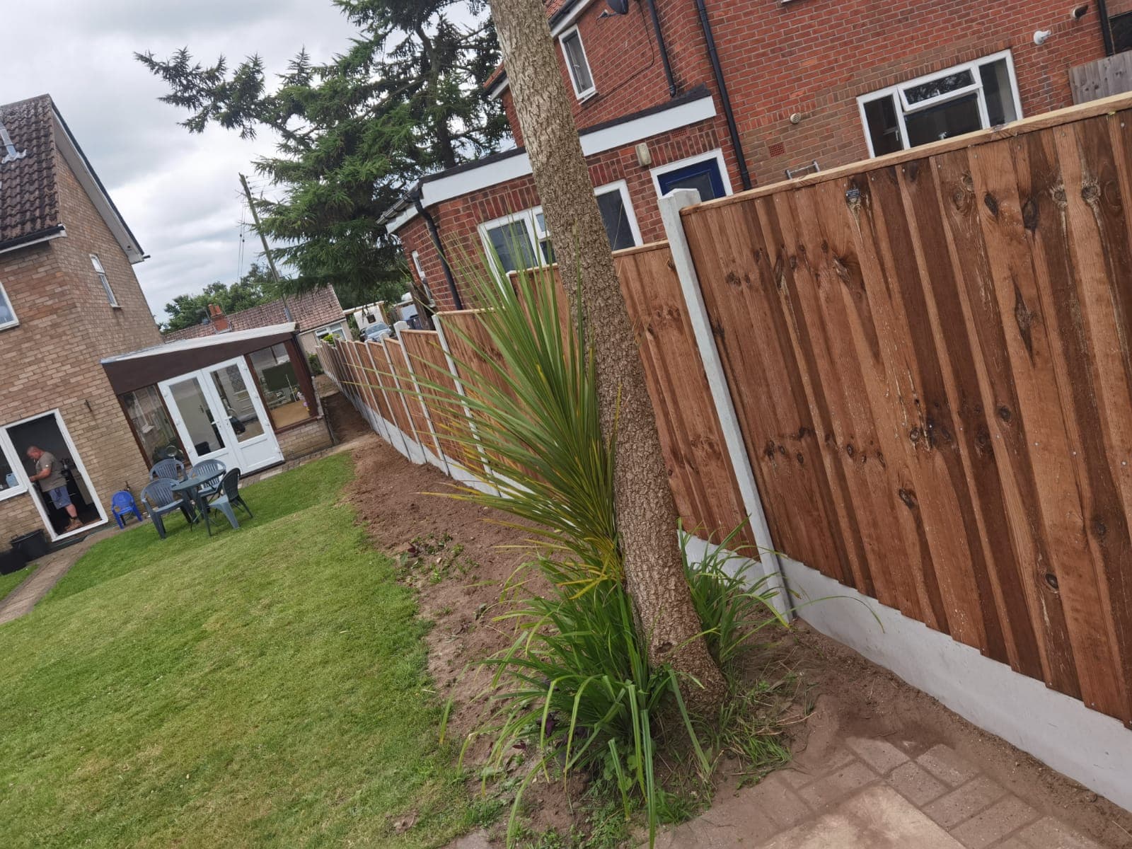 Fencing & gates Suffolk — Wooden fence panels with white base trim are the main focal point