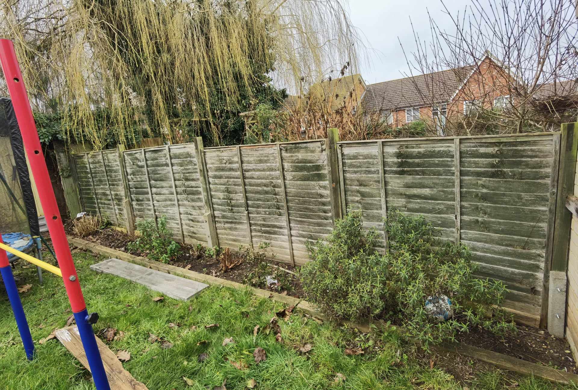 Fencing & gates Suffolk — Wooden lap fence panels are the dominant feature along garden boundary