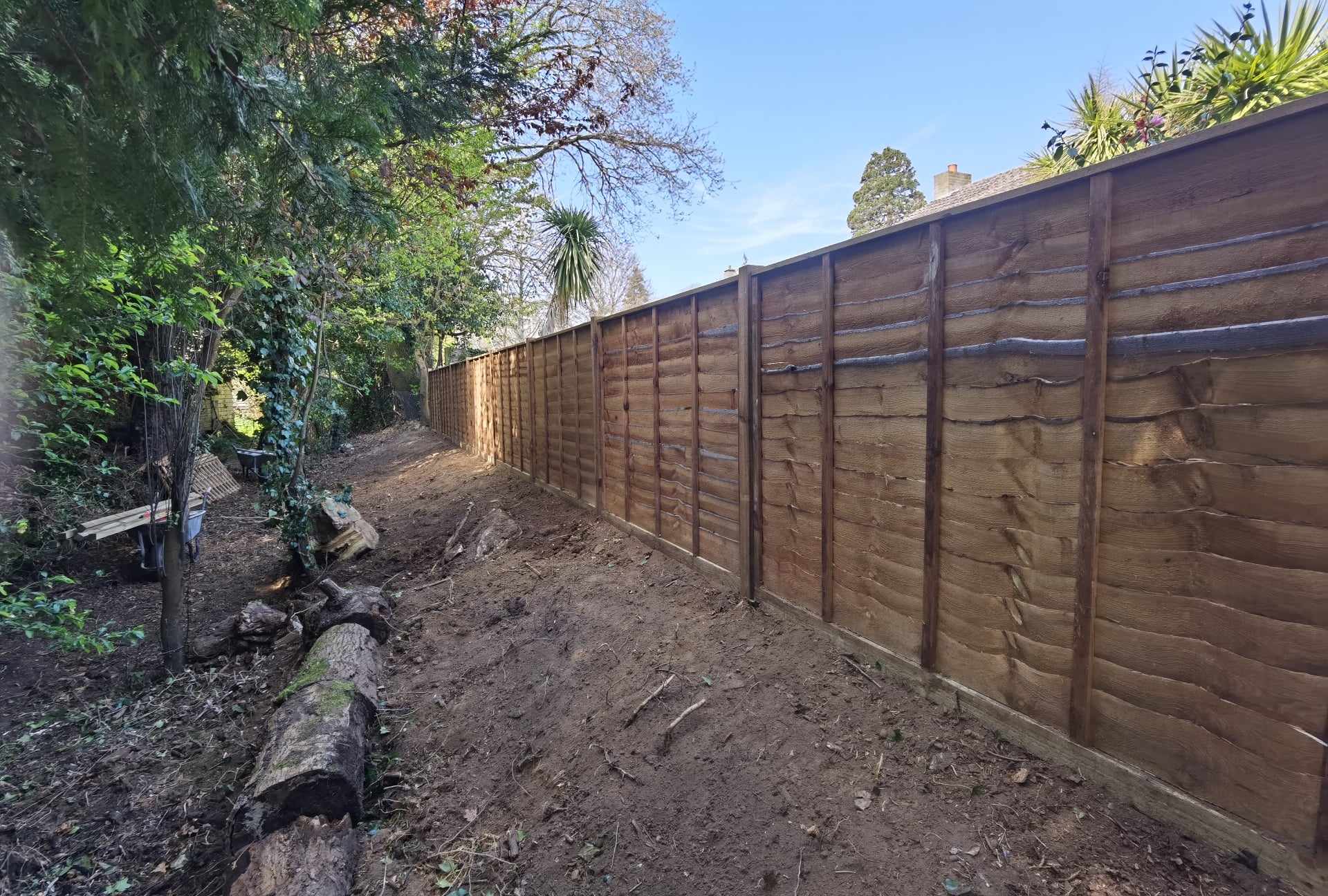 Fencing & gates Suffolk — Newly installed wooden fence panels along garden boundary with posts