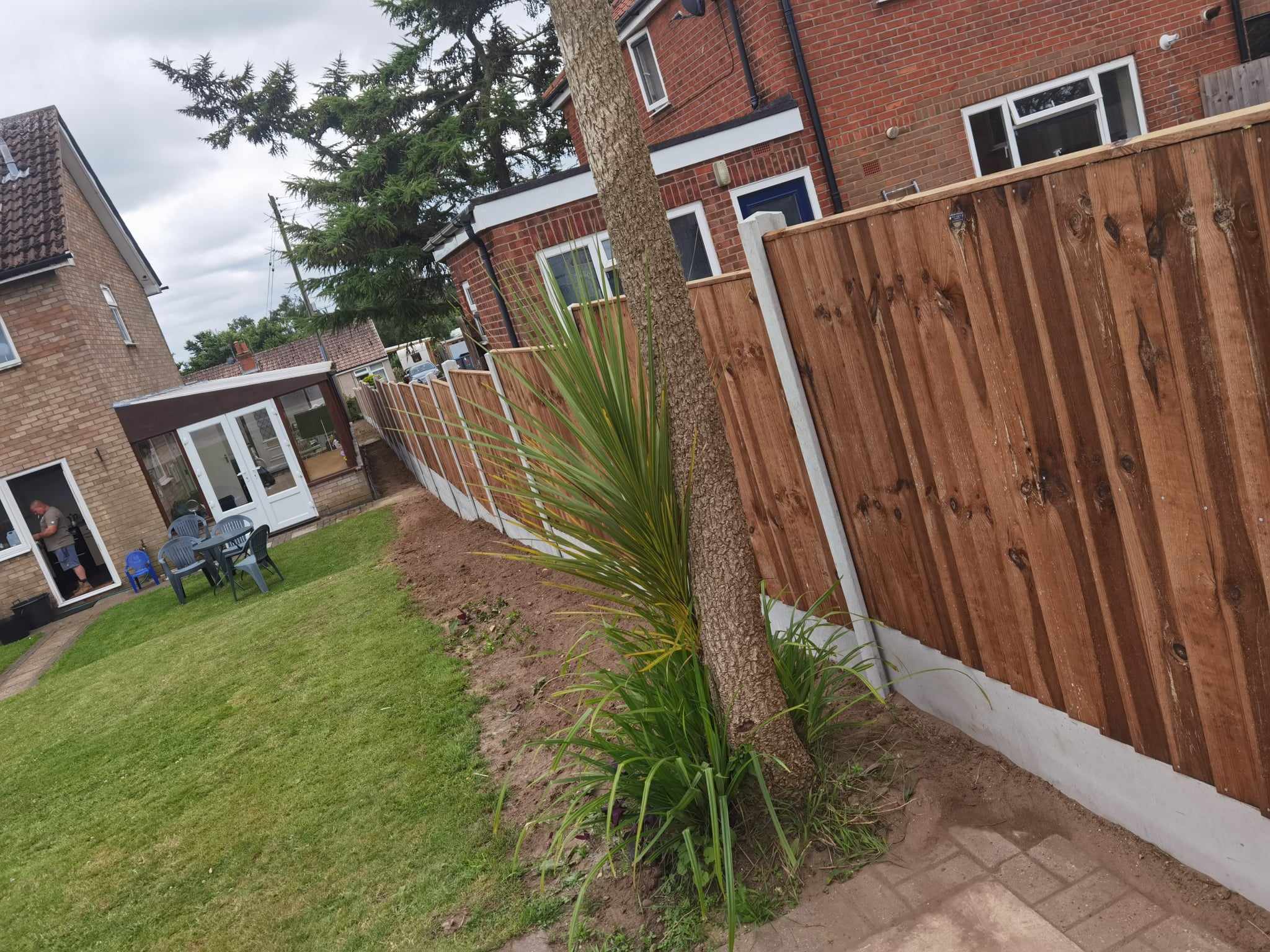 Fencing & gates Suffolk — New wooden fence installation with white concrete base trim