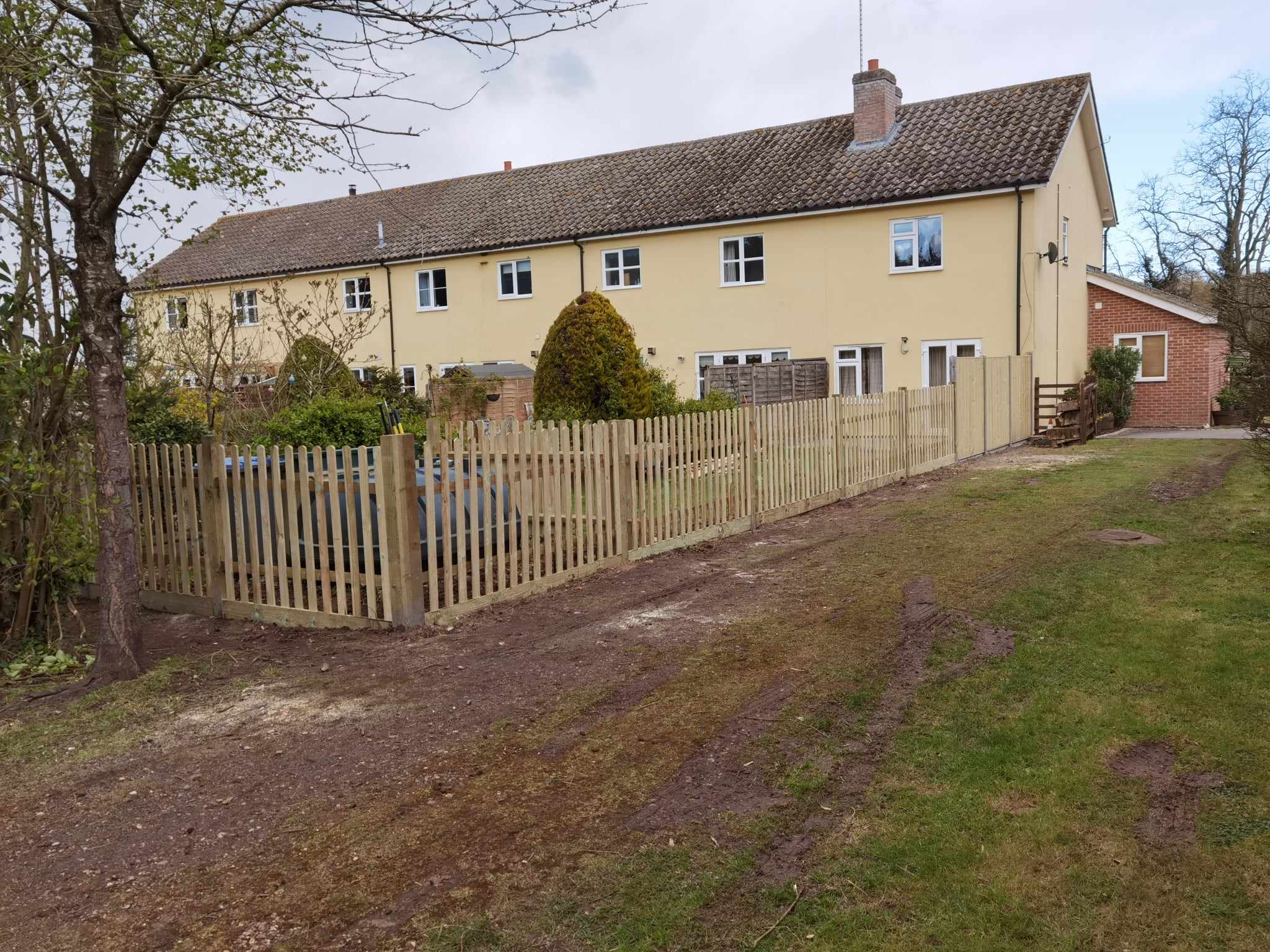 Fencing & gates Suffolk — Wooden picket fence is the main focal point of the landscaped property