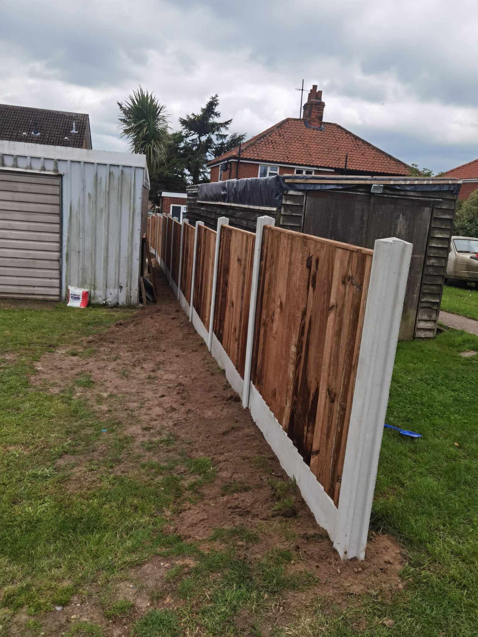 Fencing & gates Suffolk — New composite fencing installation with white posts and brown panels