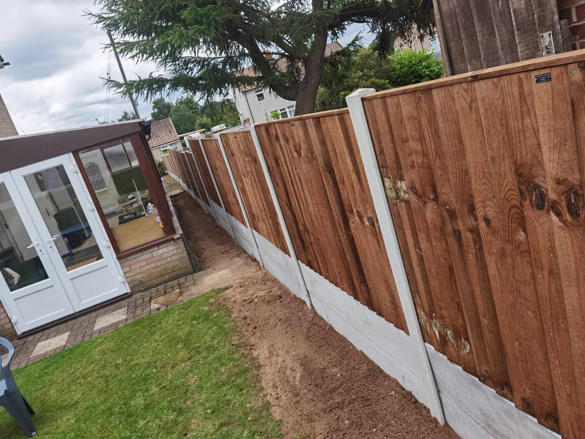 Fencing & gates Suffolk — New wooden fence installation with white concrete base panels