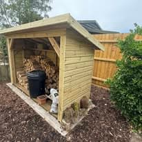 Garden landscaping project Suffolk — Garden shed with fencing, turf, and landscaping elements visible