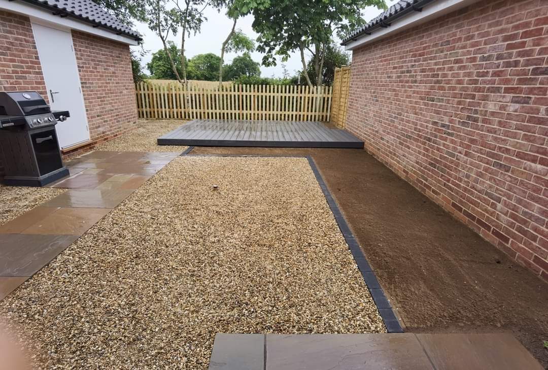 Garden landscaping project Suffolk — Finished courtyard with patio, gravel, decking, and fencing elements
