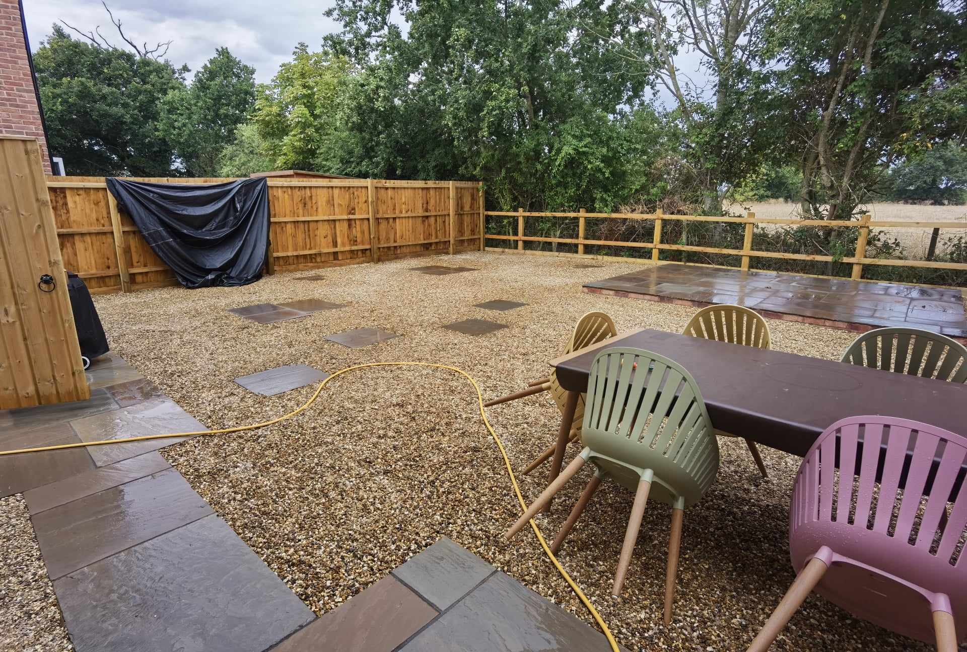 Garden landscaping project Suffolk — Finished garden space with patio, gravel, fencing, and seating area