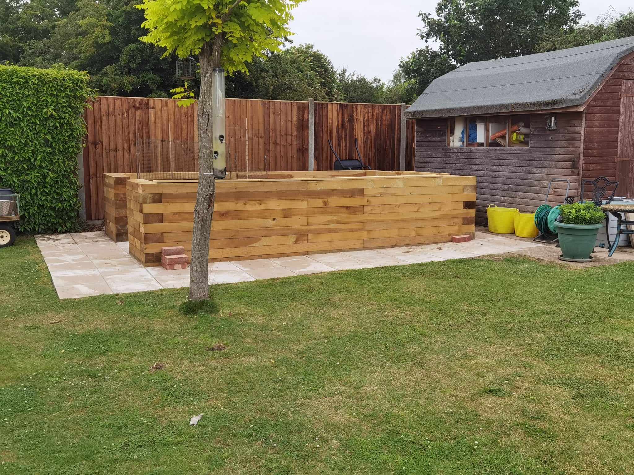 Garden landscaping project Suffolk — Complete garden view with patio, raised beds, fencing, shed, and lawn