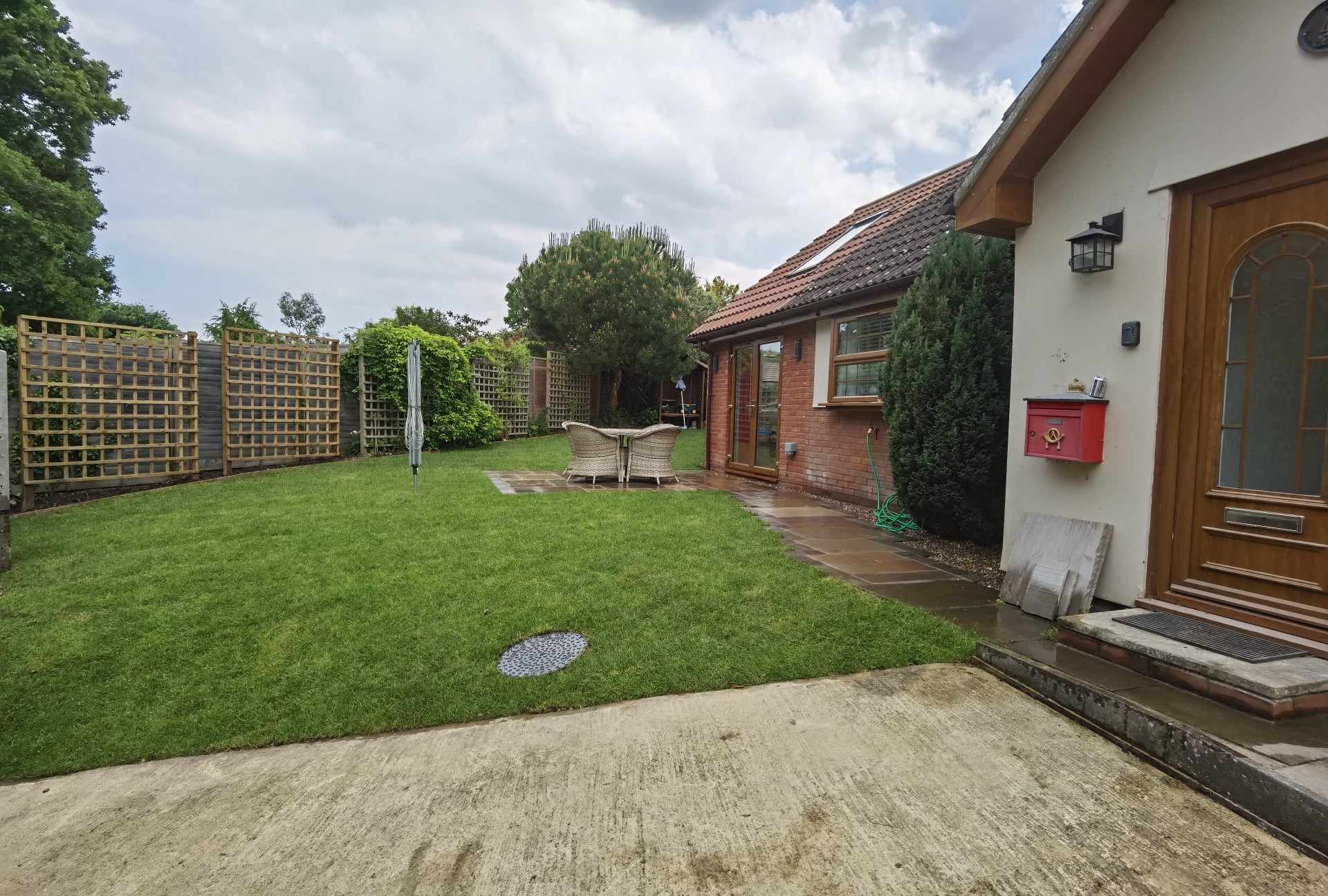 Garden landscaping project Suffolk — Complete finished garden with turf, patio, fencing, and house integration
