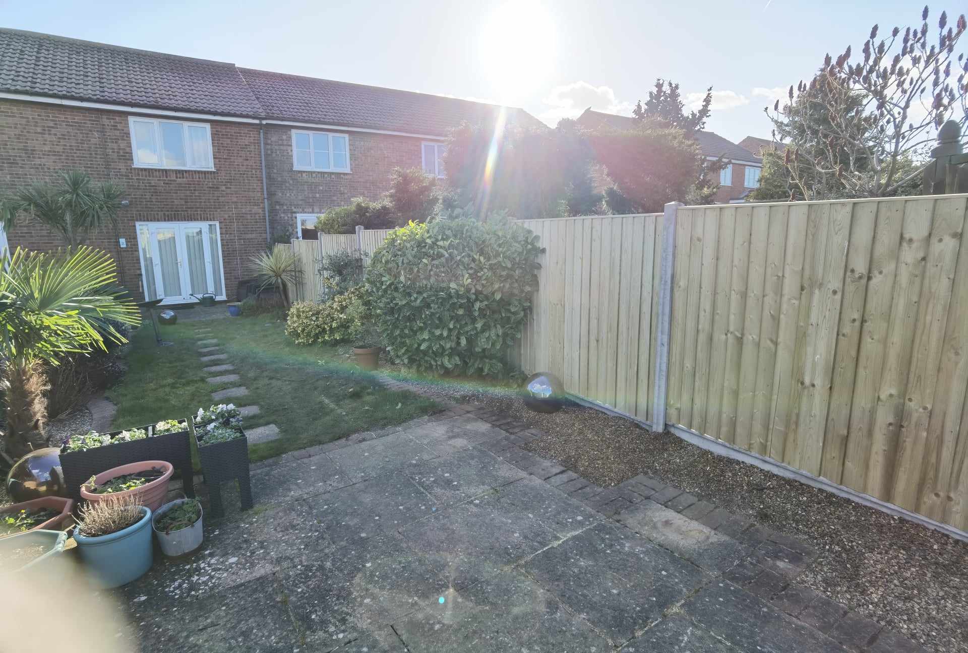 Garden landscaping project Suffolk — Wide garden view showing patio, fencing, turf, and landscaping features