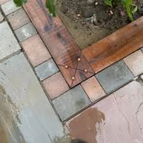 Patio installation Suffolk — Mixed material patio with Indian sandstone and porcelain pavers, wet surface