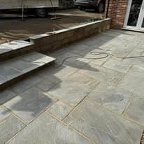Patio installation Suffolk — Stone slab patio with mixed gray tones and stepped levels
