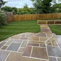 Patio installation Suffolk — Indian sandstone patio with geometric pattern layout in garden