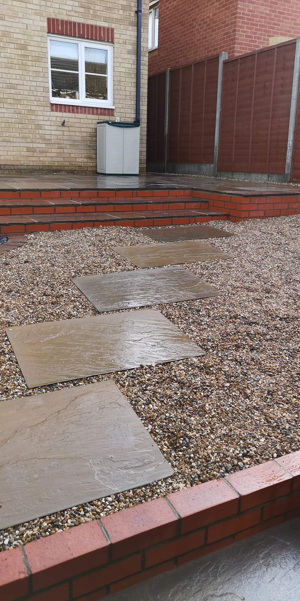 Patio installation Suffolk — Stone slabs with gravel base pathway in landscaped garden area