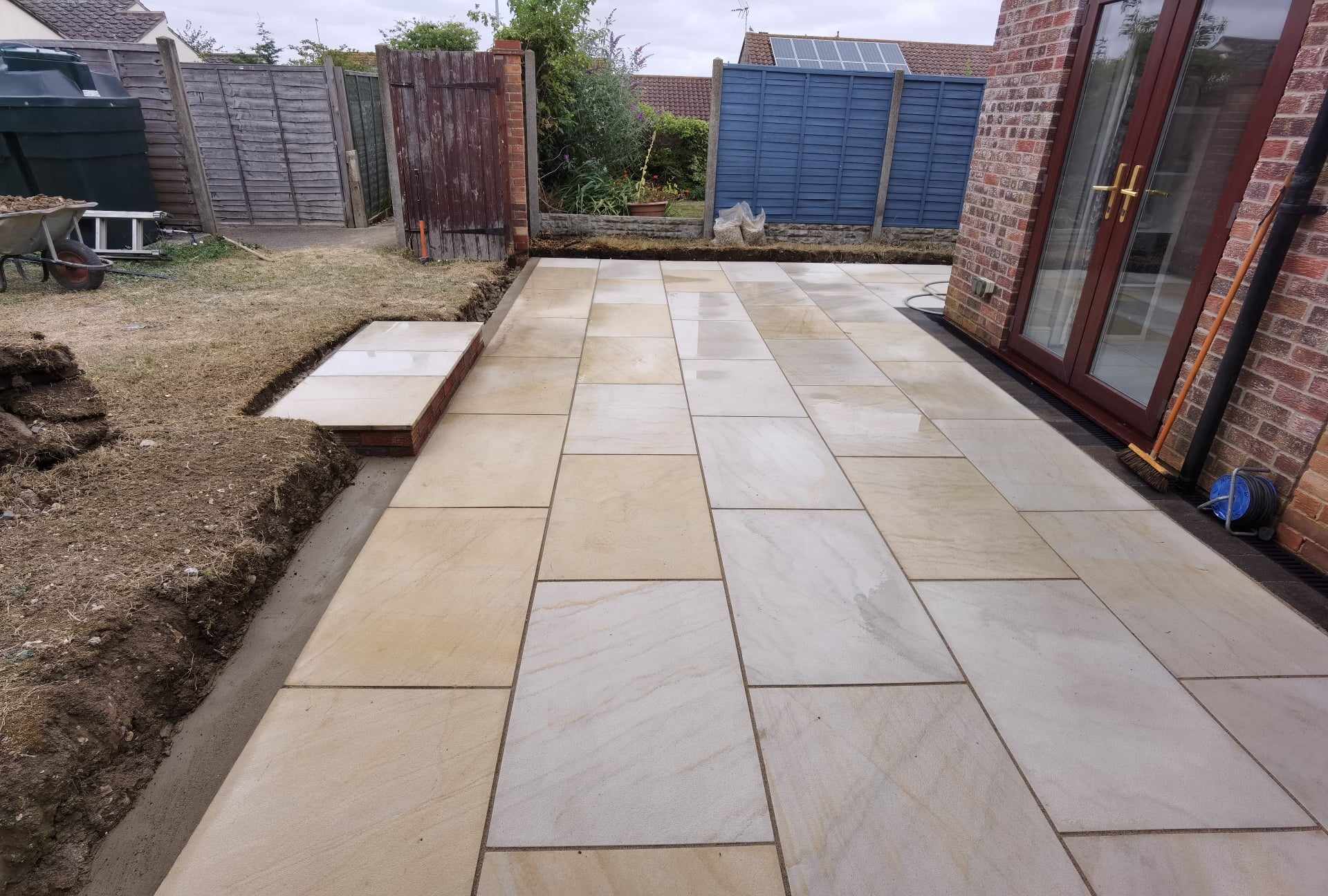 Patio installation Suffolk — Newly laid stone slab patio with natural sandstone pavers in neutral tones