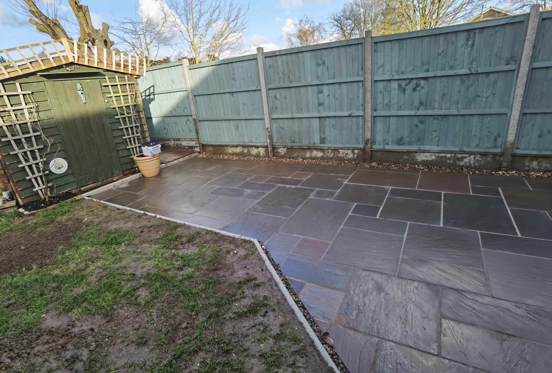 Patio installation Suffolk — Slate-effect paved patio with geometric pattern layout in enclosed garden space