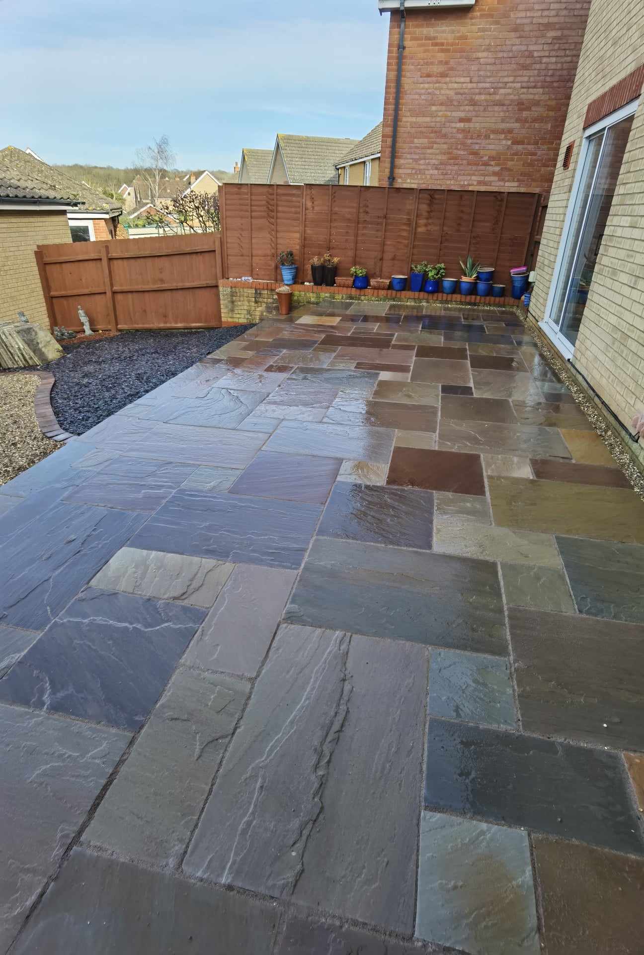 Patio installation Suffolk — Slate paving patio with mixed stone colors in completed garden space