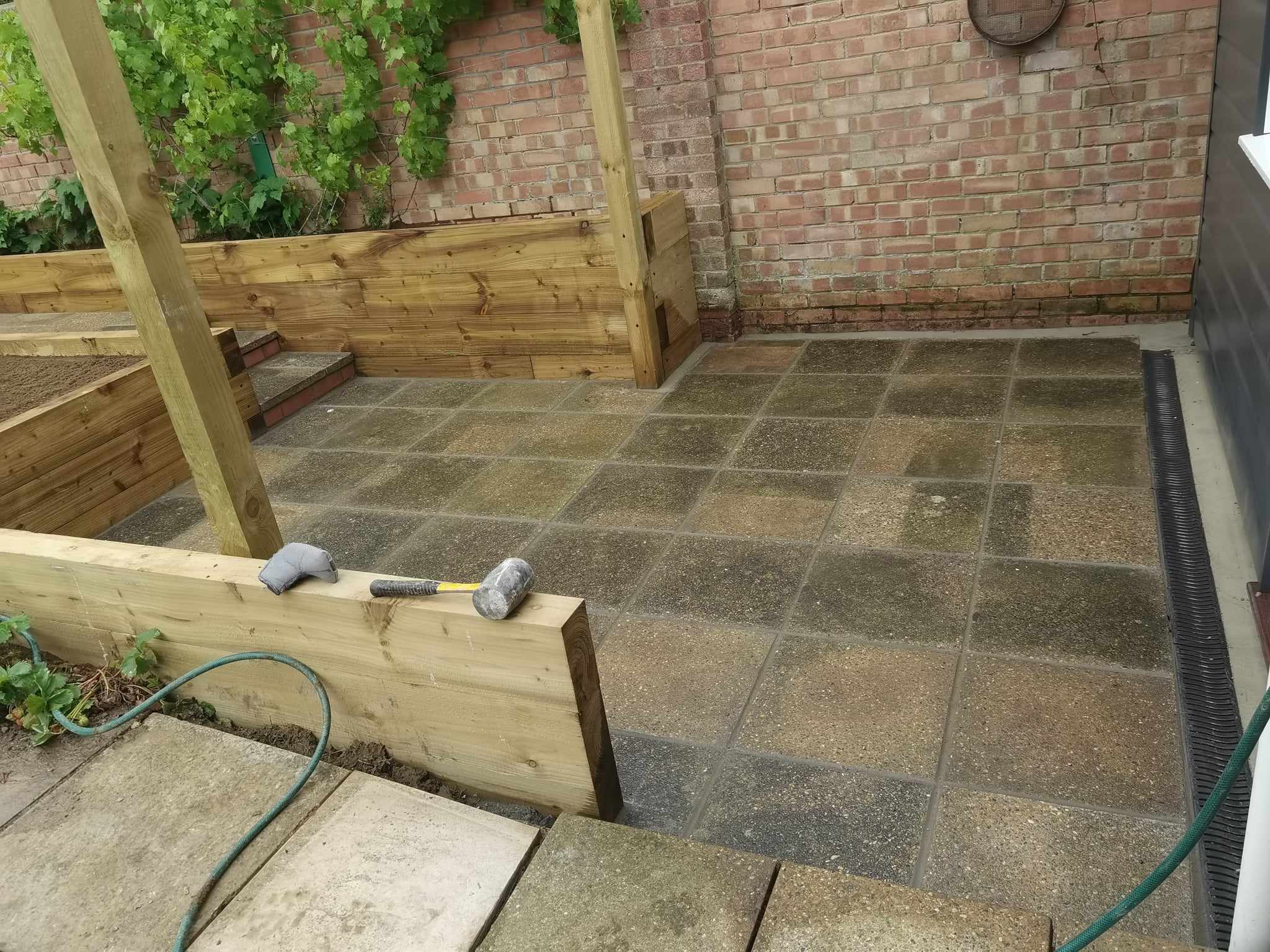 Patio installation Suffolk — Stone slab patio with geometric pattern layout under construction