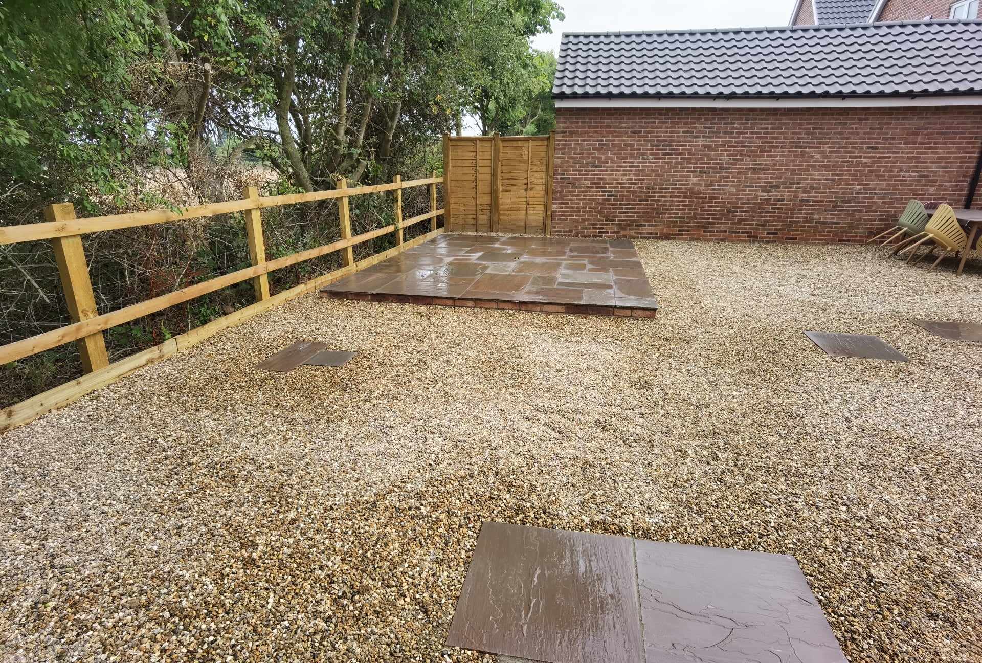 Patio installation Suffolk — Stone paved sitting area with gravel surround and wooden railings