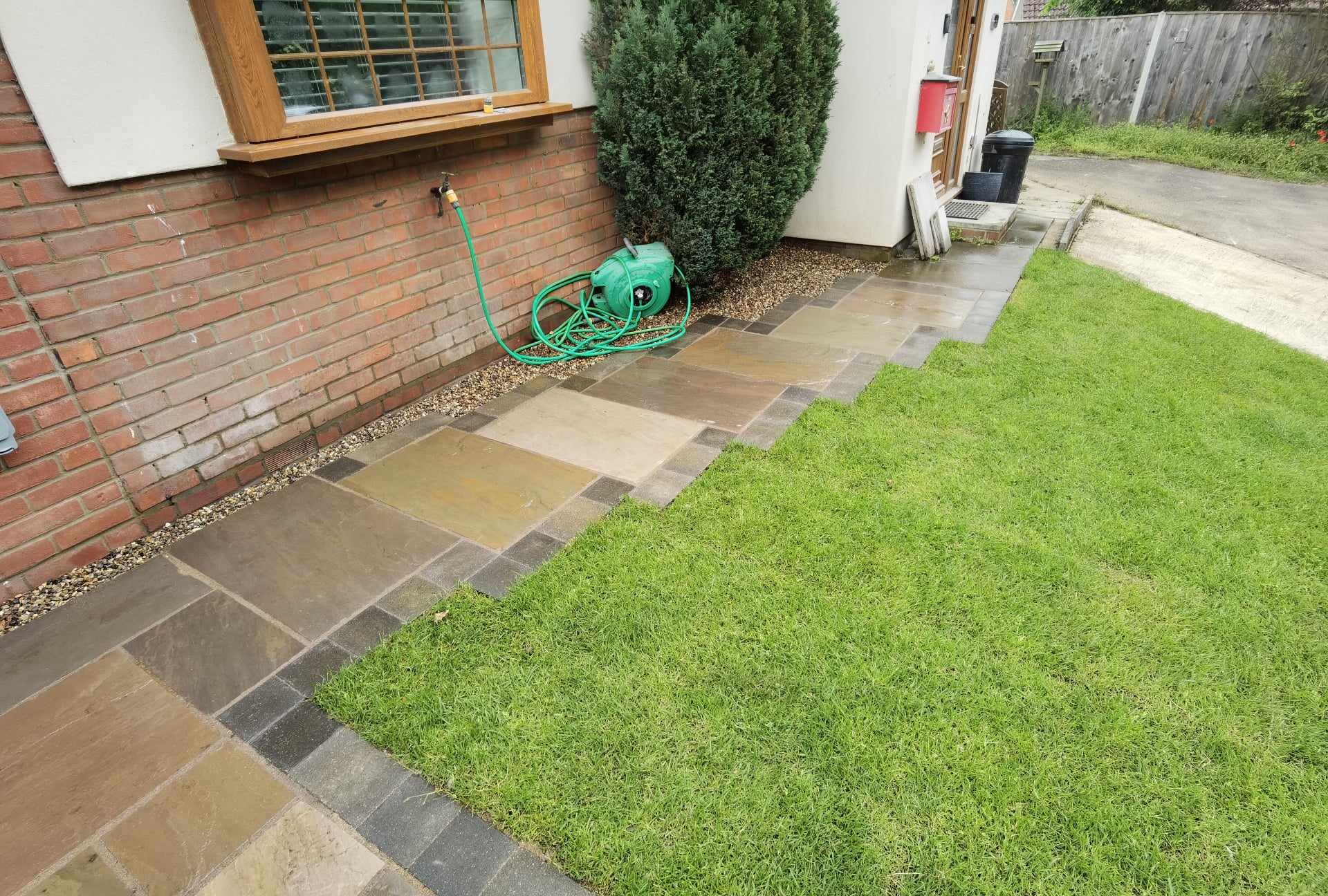 Patio installation Suffolk — Stone slab patio with varied colored pavers and edging border