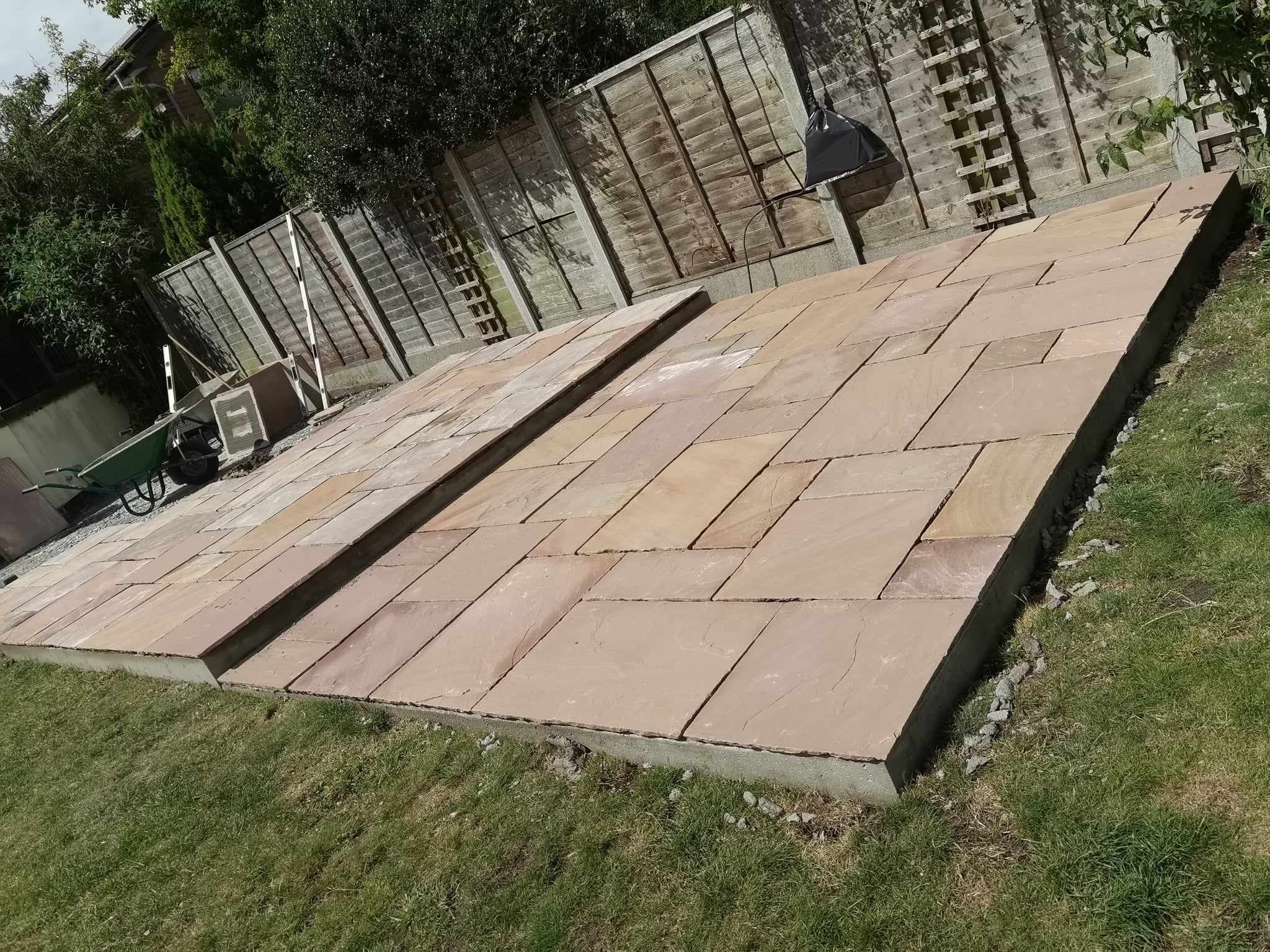 Patio installation Suffolk — Herringbone pattern Indian sandstone patio with drainage channel and manicured edges