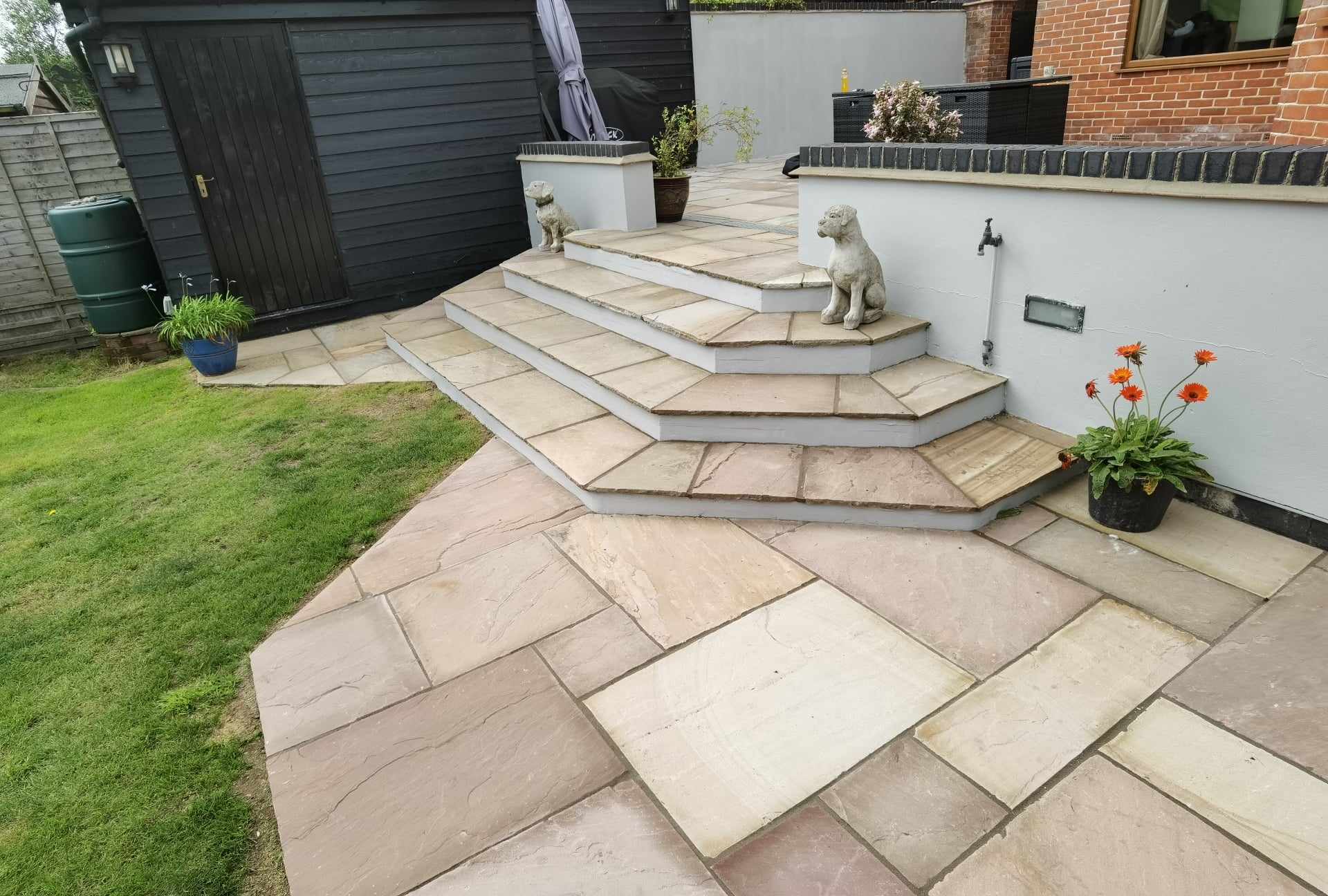 Patio installation Suffolk — Stone-slab patio with steps, herringbone pattern Indian sandstone