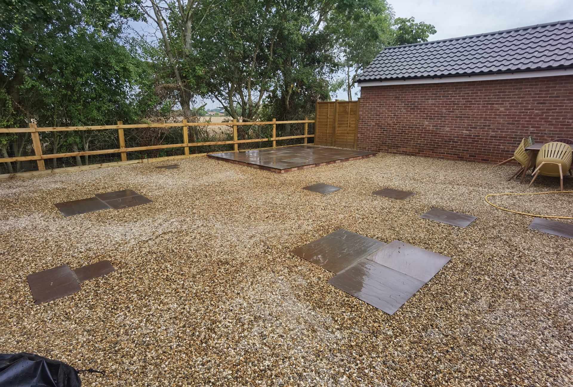 Patio installation Suffolk — Gravel patio with stepping stone pavers and wooden railings