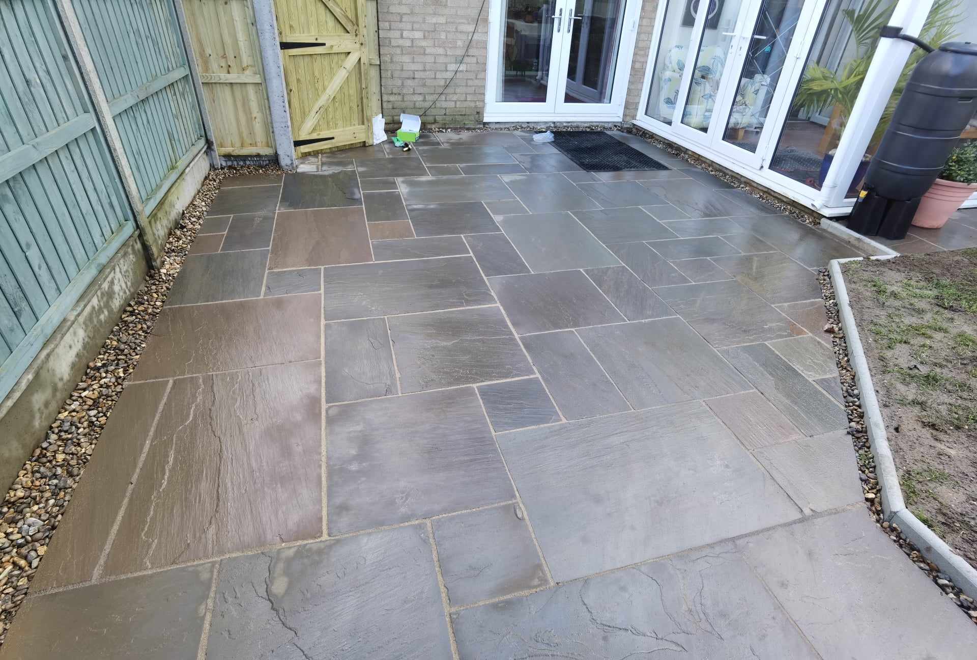 Patio installation Suffolk — Natural stone slab patio with mixed sizes in herringbone pattern layout