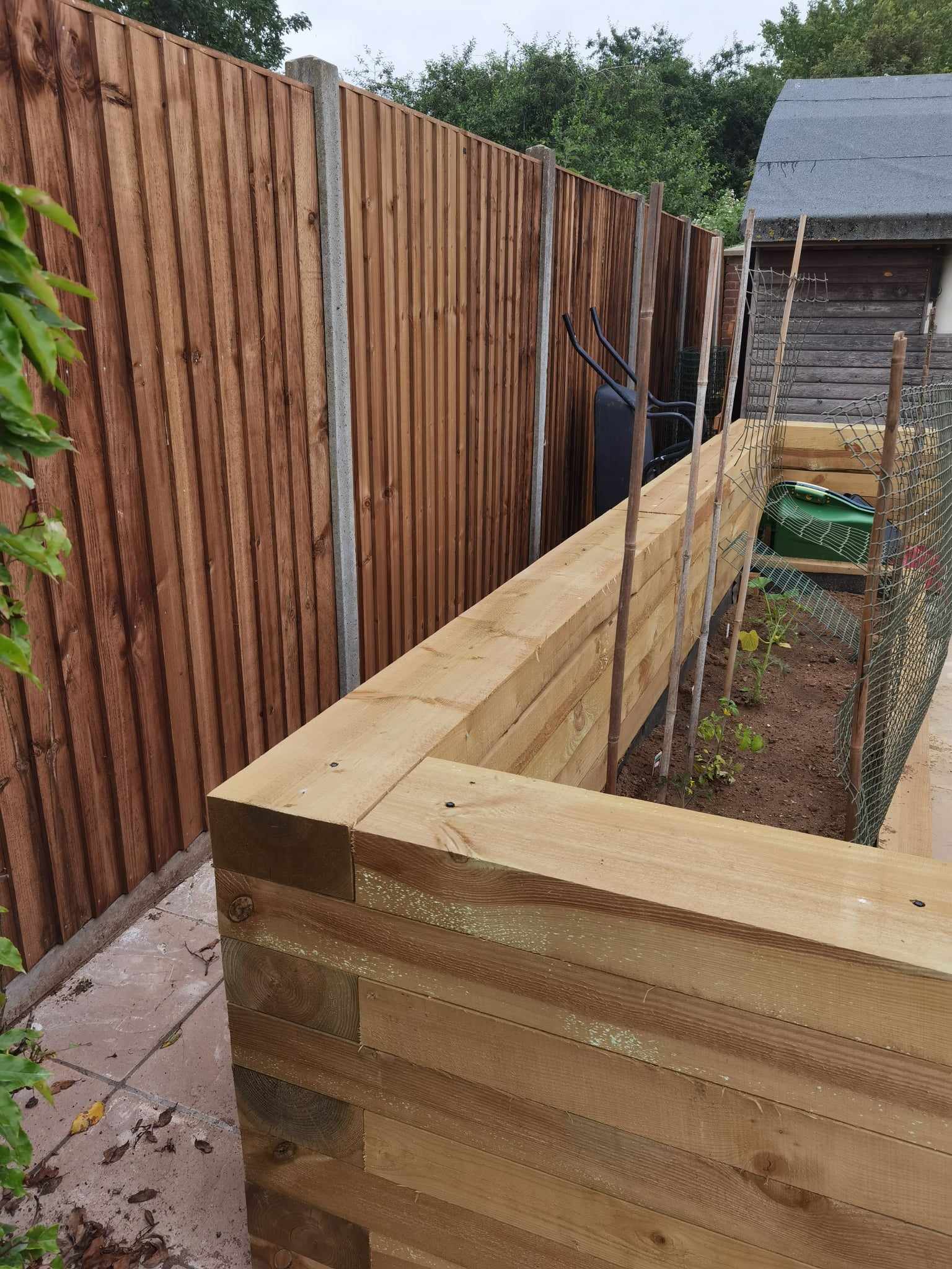 Raised bed garden Suffolk — Newly constructed wooden raised garden beds with fencing backdrop