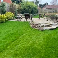 Turfing & lawn Suffolk — Well-maintained green lawn with garden features and landscaping visible