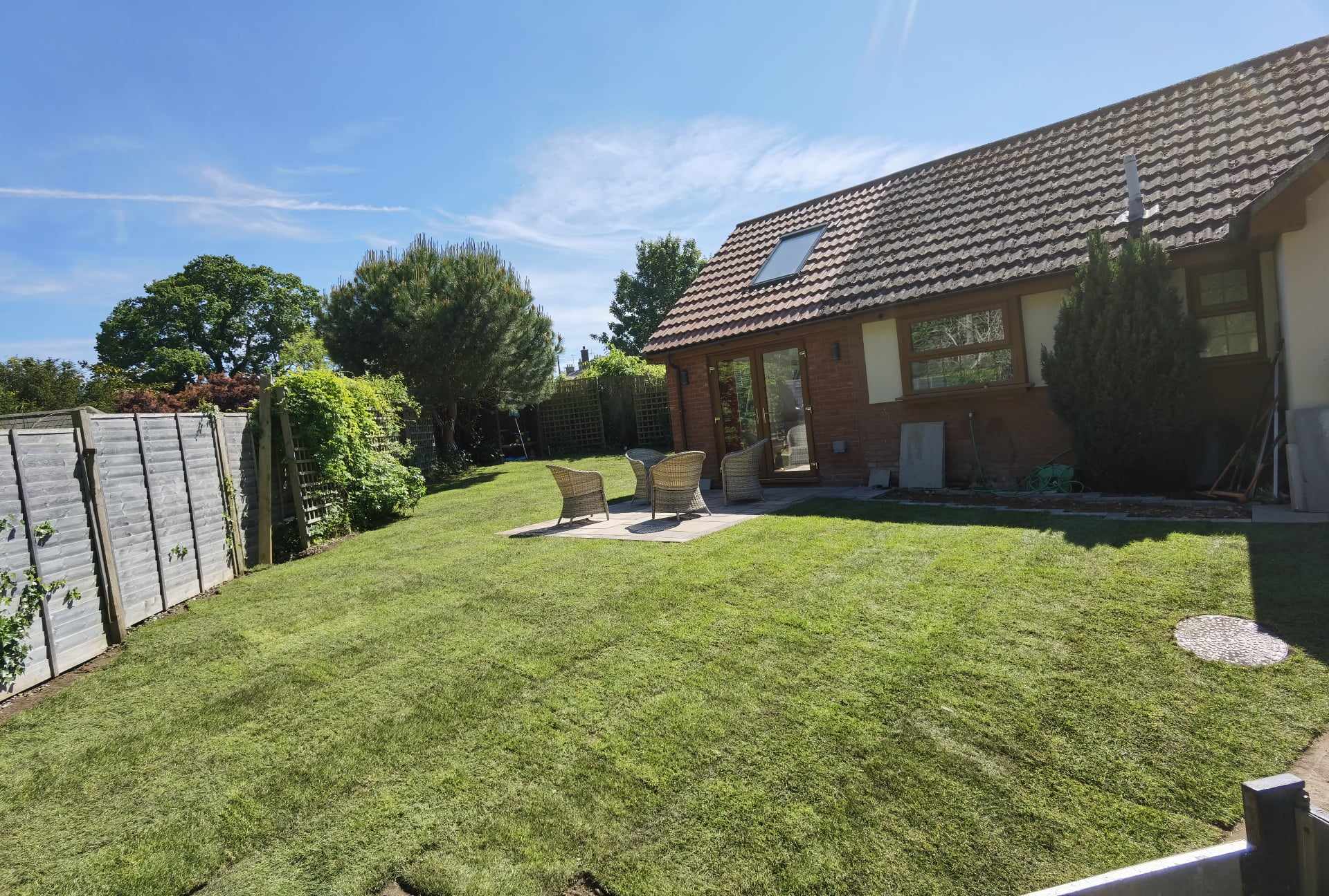 Turfing & lawn Suffolk — Well-maintained real grass lawn in residential garden space